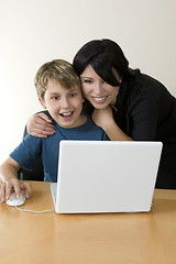 Image showing Adult and child enjoying computer time