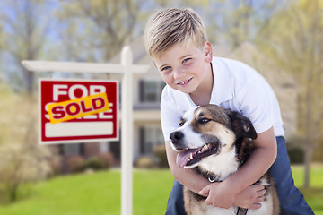 Image showing Young Boy and His Dog in Front of Sold For Sale Sign and House