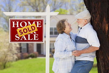 Image showing Sold Real Estate Sign with Senior Couple in Front of House