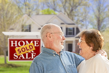 Image showing Senior Couple in Front of Sold Real Estate Sign and House