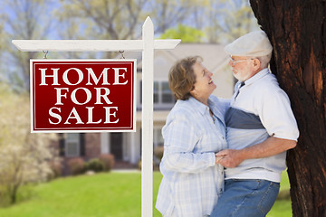 Image showing Happy Senior Couple Front of For Sale Sign and House