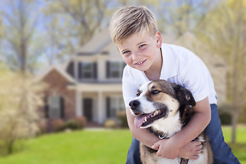 Image showing Young Boy and His Dog in Front of House