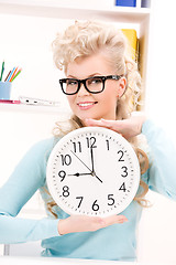 Image showing woman holding big clock