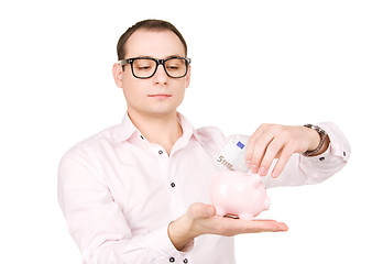 Image showing businessman with piggy bank and money