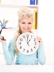 Image showing woman holding big clock