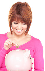 Image showing lovely woman with piggy bank and money