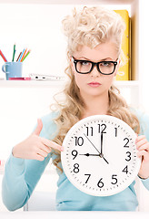 Image showing woman holding big clock