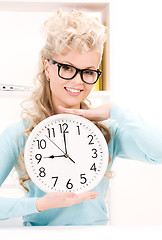 Image showing woman holding big clock