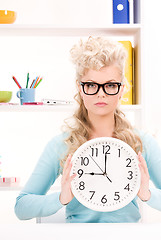 Image showing woman holding big clock