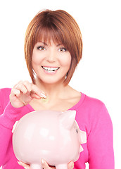 Image showing lovely woman with piggy bank and money