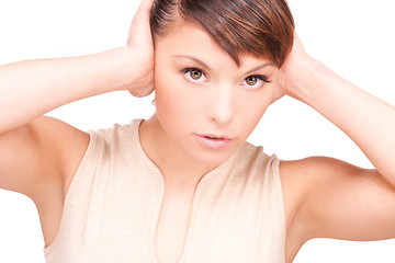 Image showing unhappy woman with hands on ears