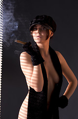 Image showing woman in black astrakhan smoking cigar