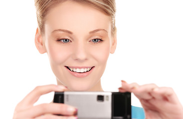 Image showing happy woman using phone camera