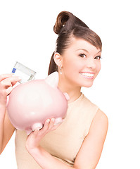 Image showing lovely woman with piggy bank and money