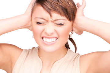 Image showing unhappy woman with hands on ears