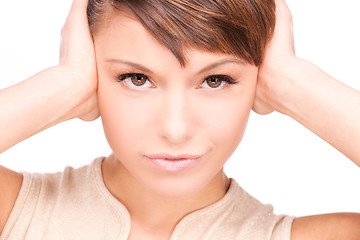 Image showing unhappy woman with hands on ears