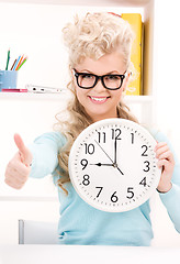 Image showing woman holding big clock