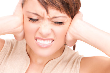 Image showing unhappy woman with hands on ears