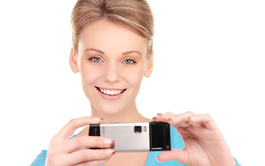 Image showing happy woman using phone camera