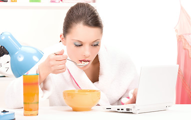 Image showing eating woman laptop computer