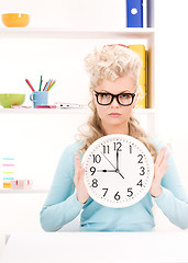 Image showing woman holding big clock