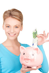 Image showing lovely woman with piggy bank and money