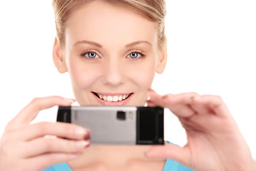 Image showing happy woman using phone camera