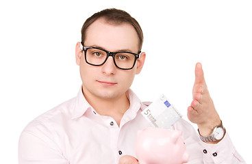 Image showing businessman with piggy bank and money