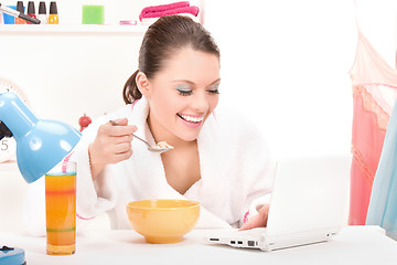 Image showing eating woman laptop computer