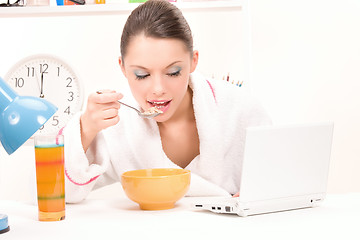 Image showing eating woman laptop computer