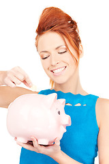 Image showing lovely woman with piggy bank