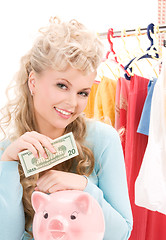 Image showing lovely woman with piggy bank and money