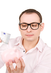 Image showing businessman with piggy bank and money