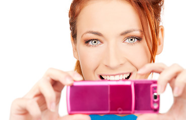 Image showing happy woman using phone camera