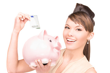 Image showing lovely woman with piggy bank and money