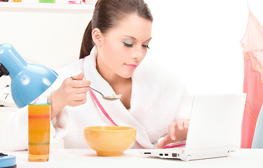 Image showing eating woman laptop computer