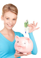 Image showing lovely woman with piggy bank and money