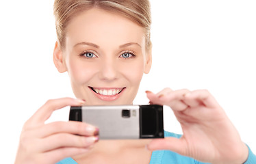 Image showing happy woman using phone camera