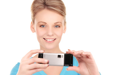 Image showing happy woman using phone camera