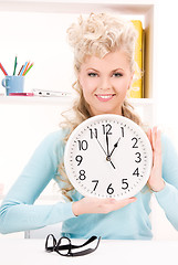 Image showing woman holding big clock