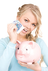 Image showing lovely woman with piggy bank and money