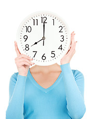 Image showing woman with big clock covering face