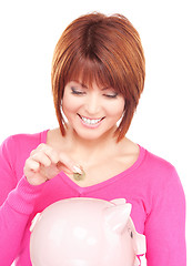 Image showing lovely woman with piggy bank and money