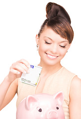 Image showing lovely woman with piggy bank and money