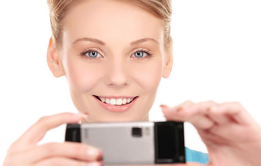 Image showing happy woman using phone camera