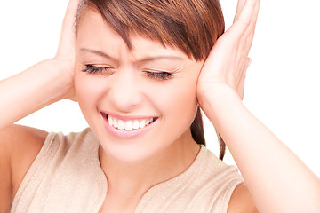 Image showing unhappy woman with hands on ears