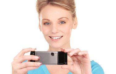 Image showing happy woman using phone camera