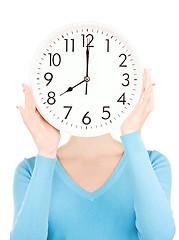 Image showing woman with big clock covering face