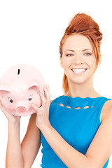 Image showing lovely woman with piggy bank