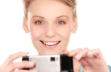 Image showing happy woman using phone camera